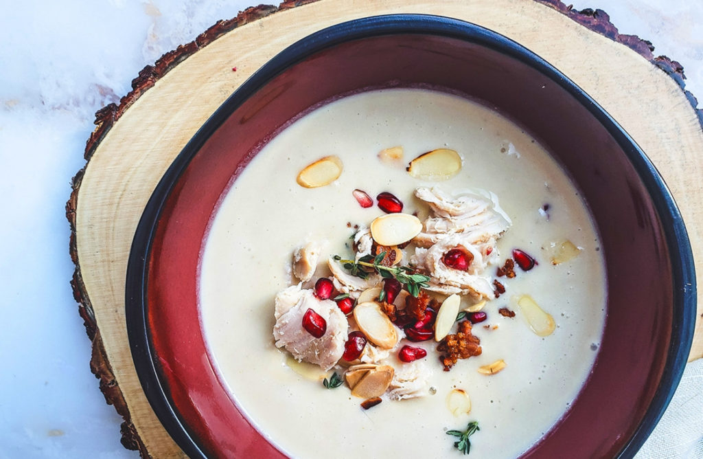 turkey cream soup with bacon, pine nuts, and pomegranate garnish