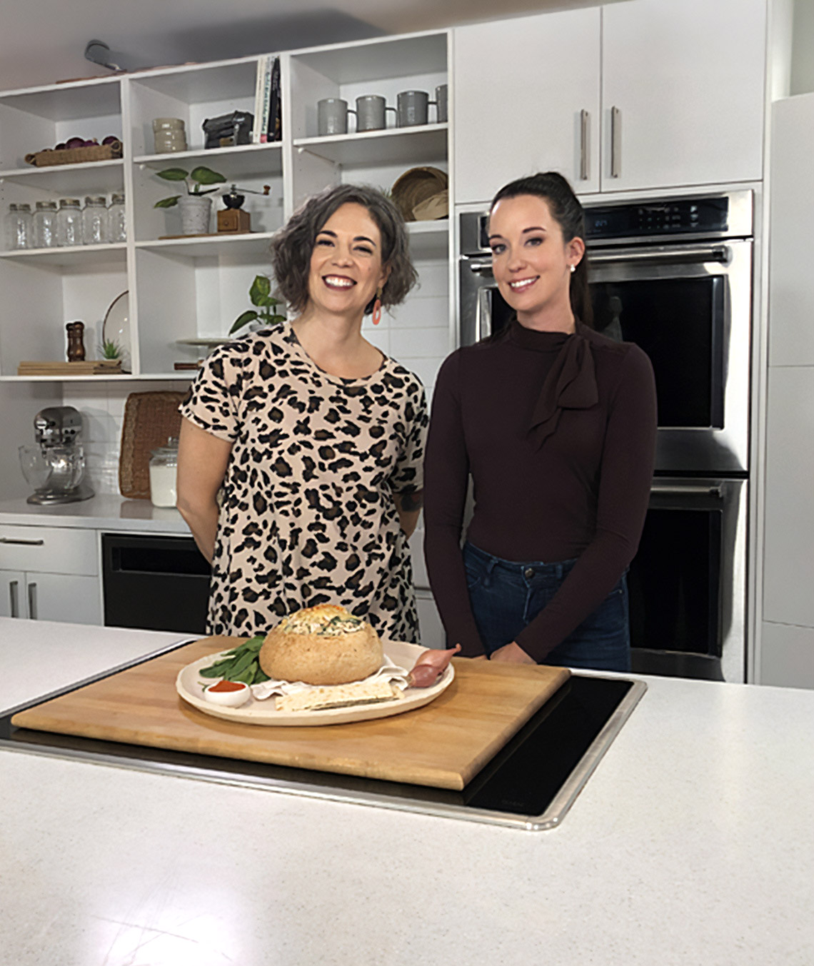 host and guest presenting the cooked dish
