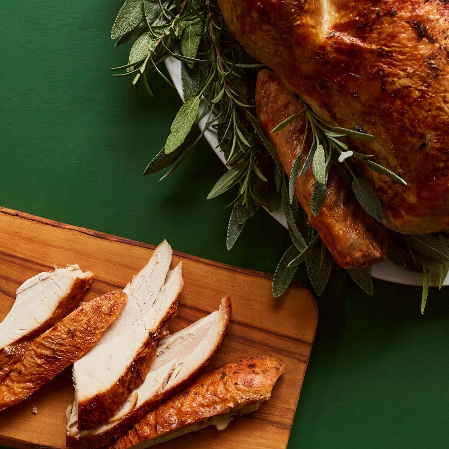 whole turkey sliced on a cutting board