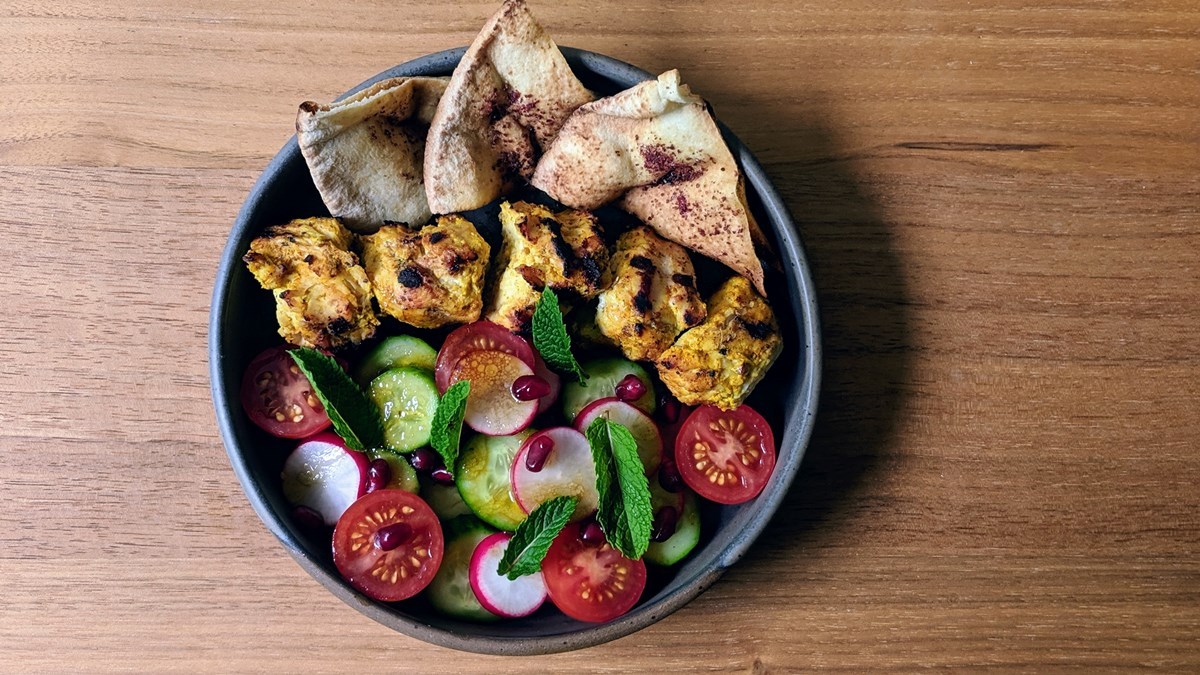 BBQ Turkey Skewers with Zaatar, Fattoush Salad and Sumac Pita in a pan