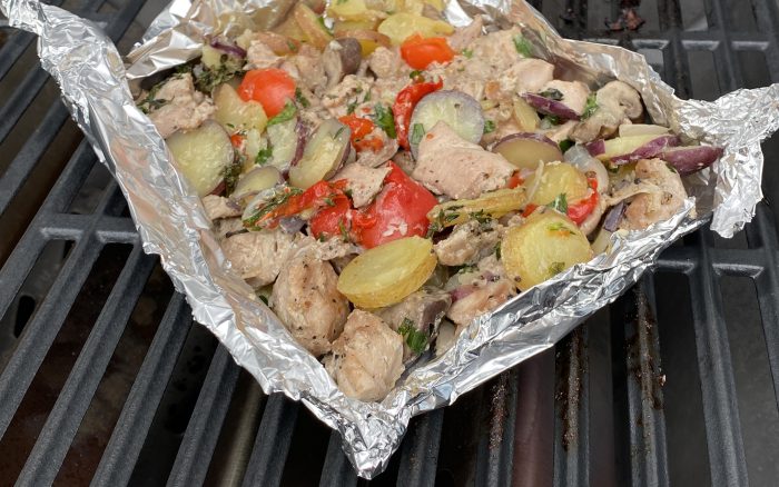 foil packed turkey and vegetables on the grill