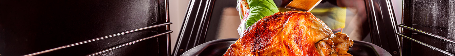 cooked turkey coming out of the oven