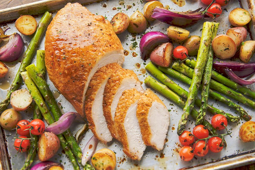 sliced turkey breast on pan with vegetables