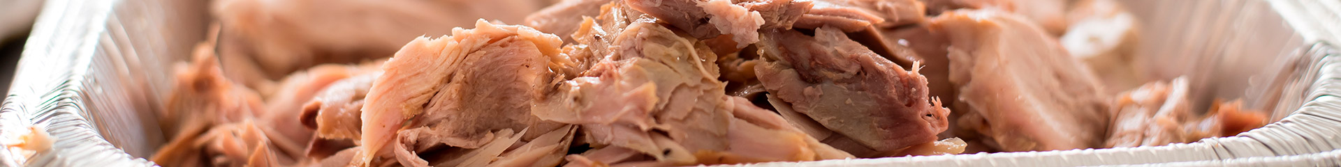 cooked turkey pieces in a foil pan