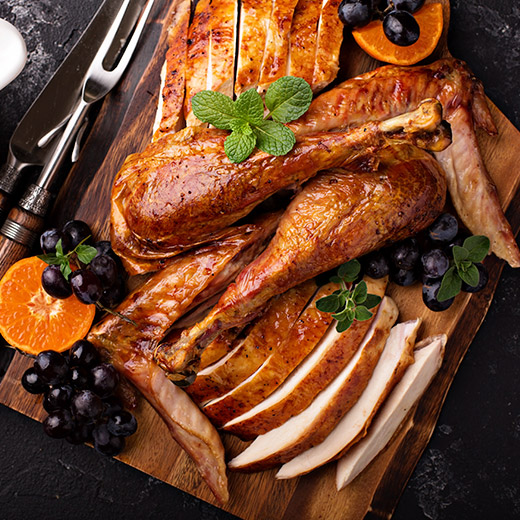 cooked turkey cut in pieces presented on a cutting board