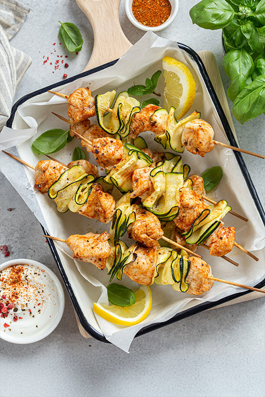 turkey kebabs with sliced lemon in a serving dish