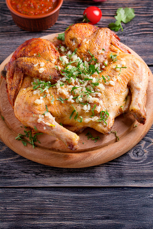 spatchcock cooked whole turkey on a cutting board